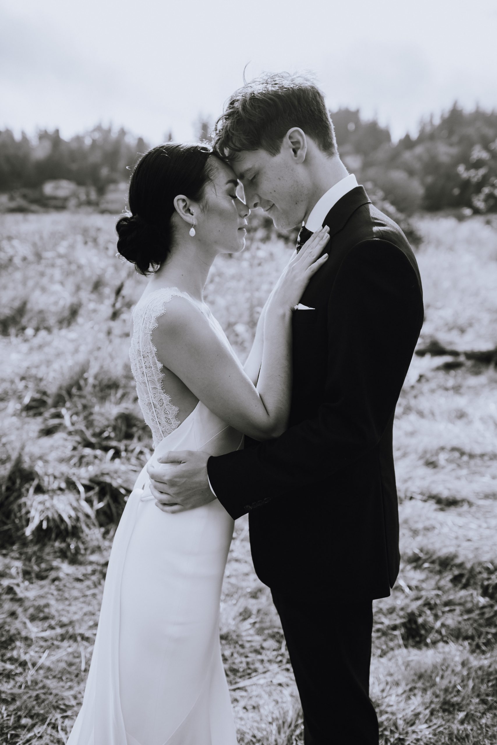 Wedding couple posed in a field in Victoria BC captured by photographer Shantal of Third Wheel Wedding Co.